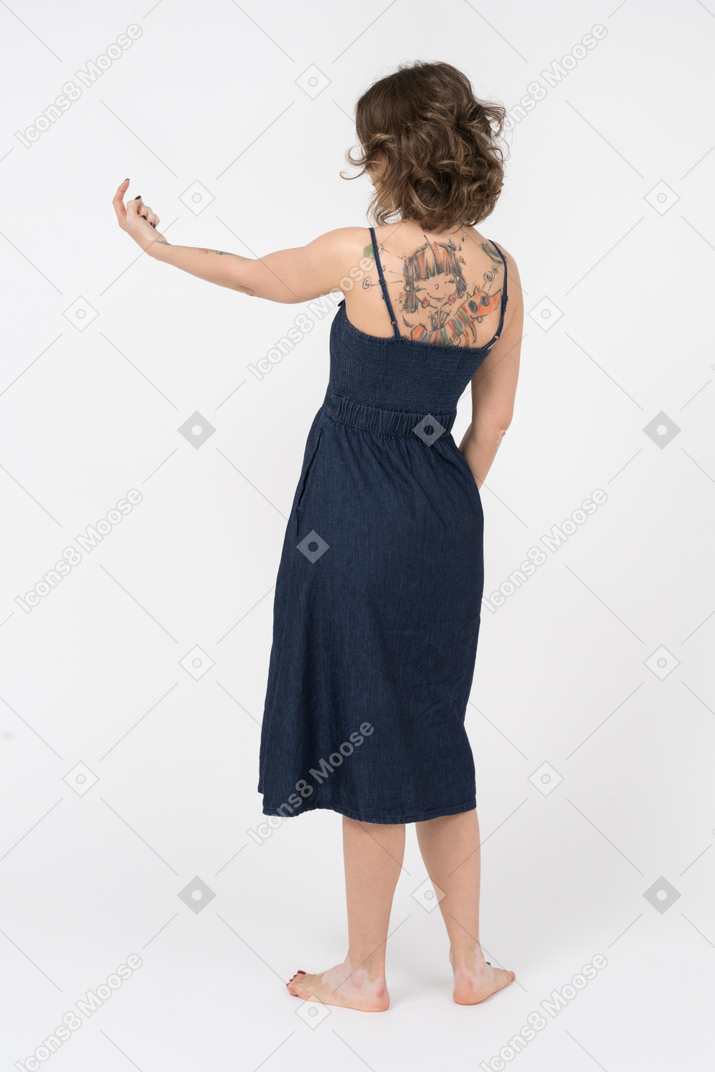 Unrecognizable young woman beckoning somebody with a finger