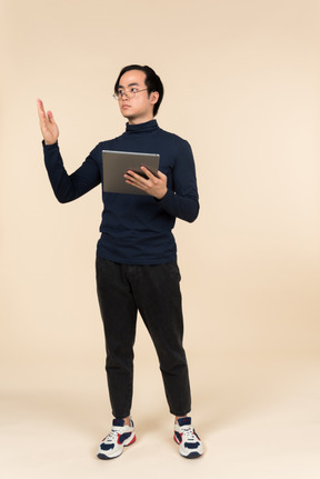 Young asian man presenting a digital tablet