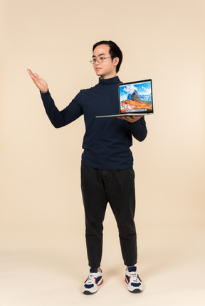 Young asian man presenting a laptop