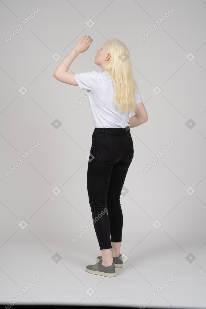 Back view of girl covering face from sun