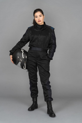 A beautiful female biker posing with a helmet