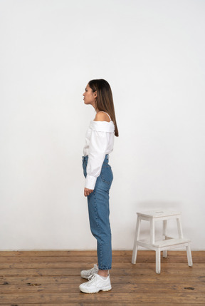 Profile of a young woman in jeans and shirt