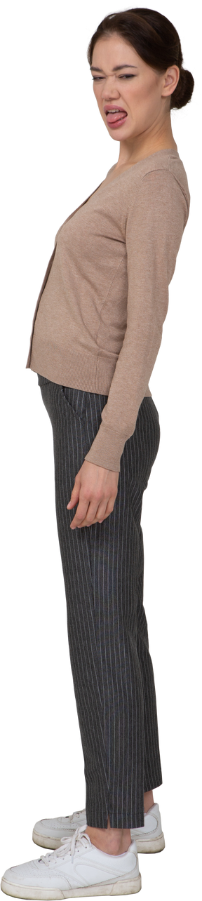 Side view of a grimacing young lady in beige pullover