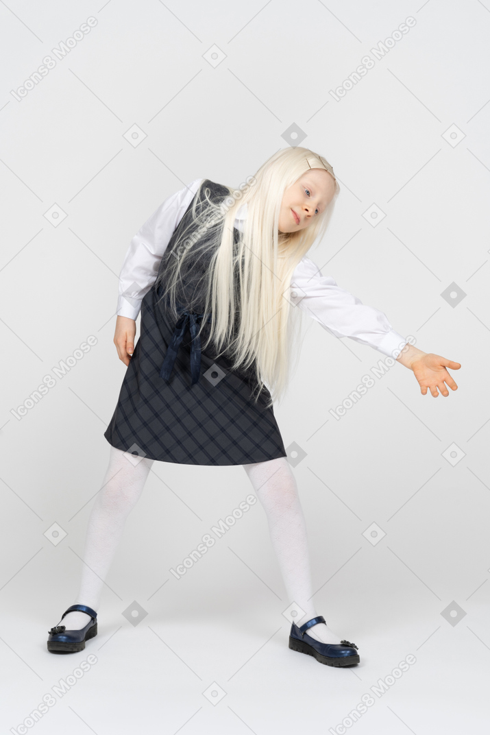 Schoolgirl leaning sideways with arm stretched out