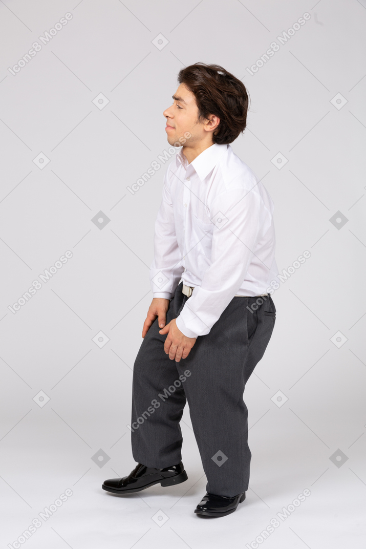 Side view of man touching legs with pain