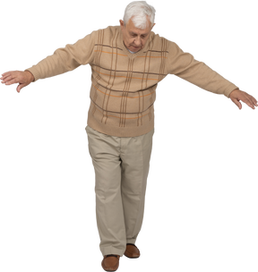 Vista frontale di un vecchio in abiti casual che cammina in avanti con le braccia tese