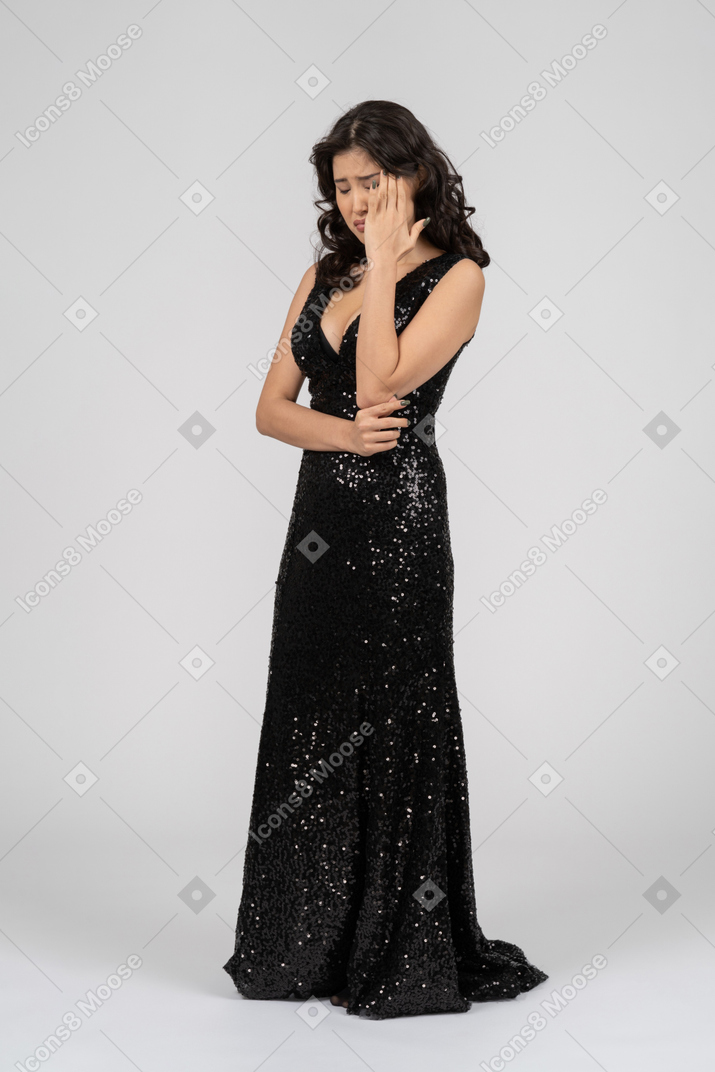 Upset woman wearing black evening dress
