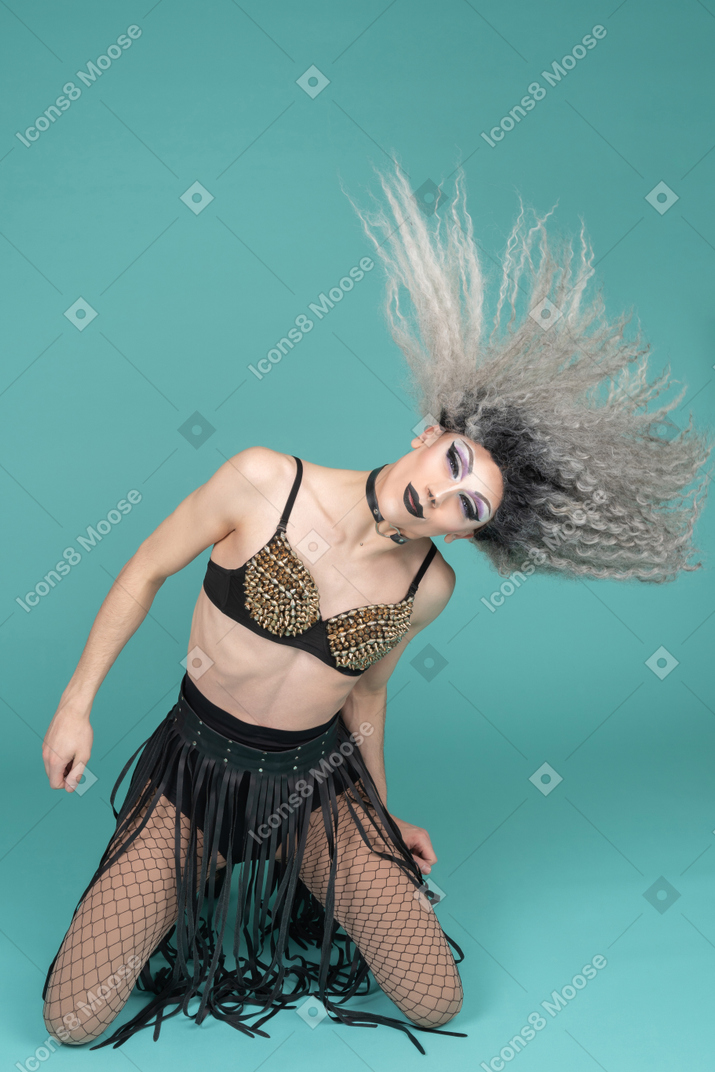 Drag queen standing on knees and whipping their hair