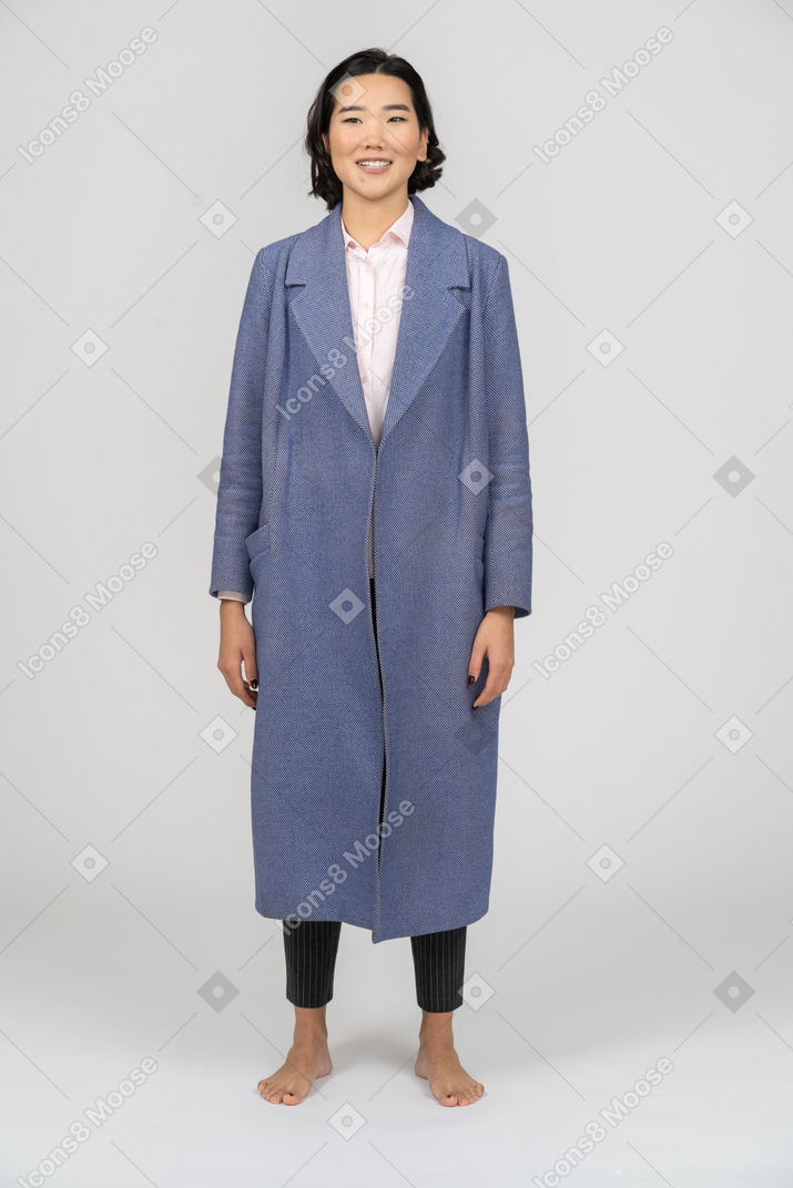 Front view of a smiling woman in blue coat