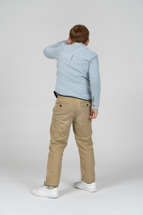 Back view of boy in blue shirt and khaki pants