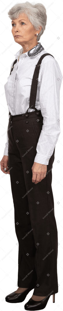 Side view of a confident old female dressed in office clothes