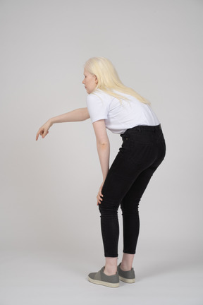 Back view of a woman pointing down