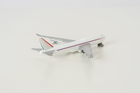 Toy airplane on grey background