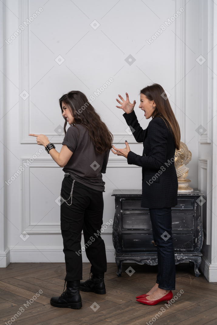 Two women scolding someone