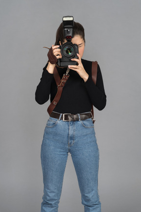 Female photographer taking picture in front of camera