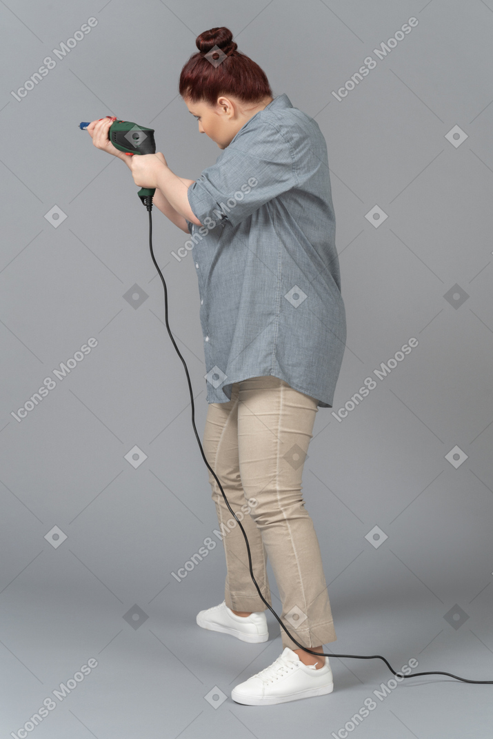 Young woman preparing to screw drive