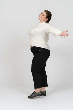 Happy plump woman in casual clothes posing