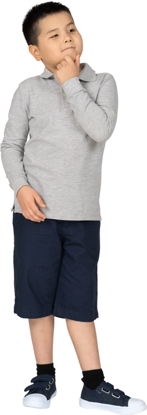 Little boy touching his chin