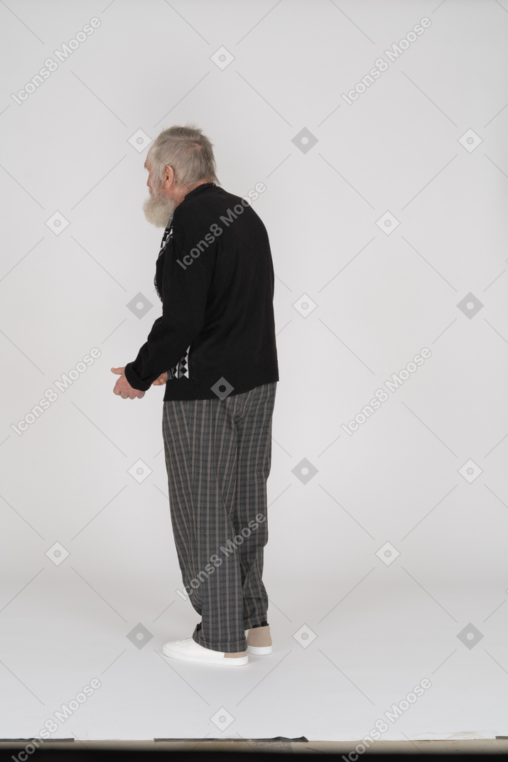 Three-quarter back view of an old man slouching slightly