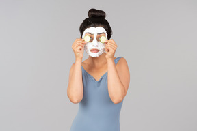 Woman with white mask on sending air kisses