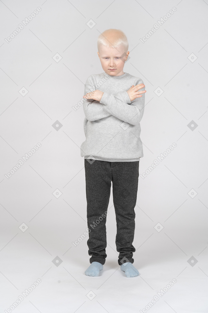 Little boy with his hands crossed