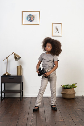 Cute girl posing on the background of the apartment