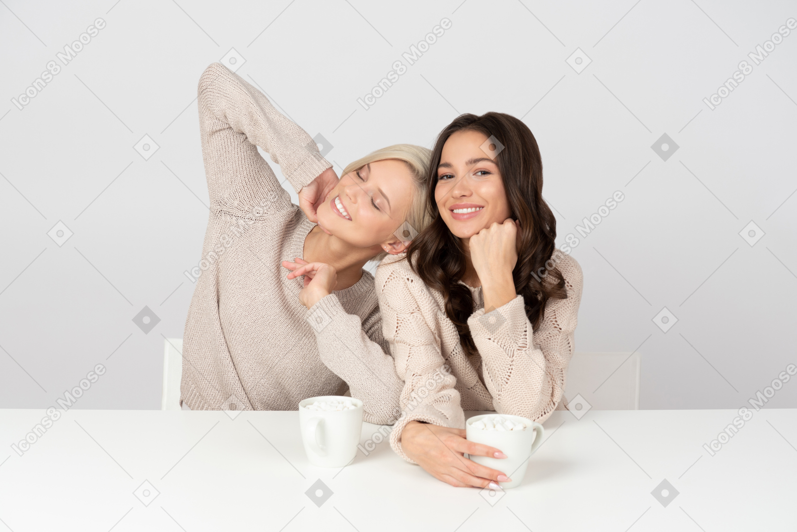 Joyful young women drinking coffee