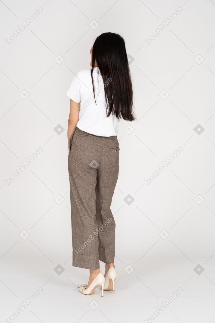 Vista posteriore di una giovane donna in calzoni