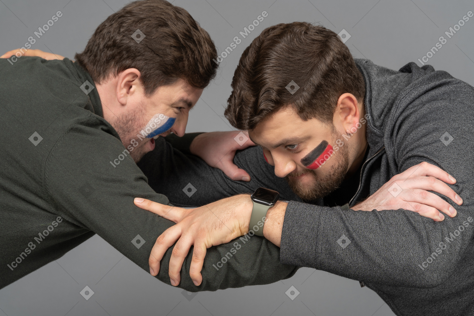 Side view of two fighting male football fans
