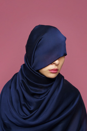 Close-up a young female wrapped in dark blue cloth