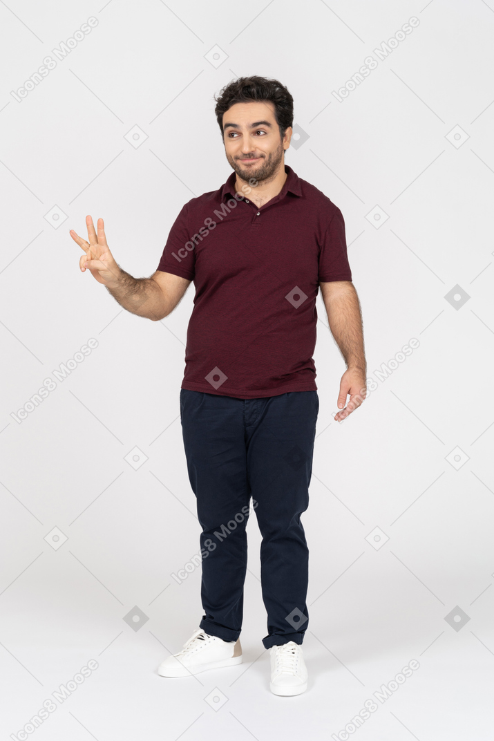 Smiling man showing three fingers