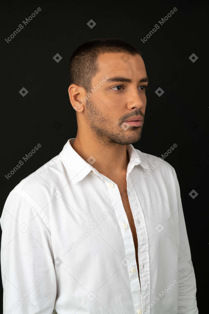 Attractive young man immersed in his thoughts