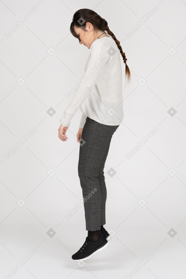 Young woman levitating in profile