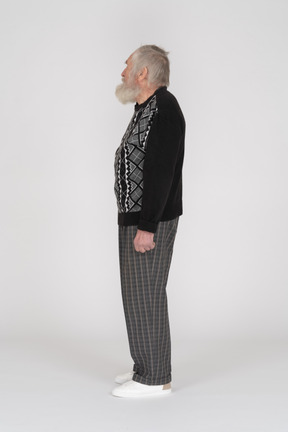Side view of an old man standing still