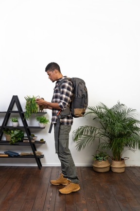 Side view of a tourist holding a flask