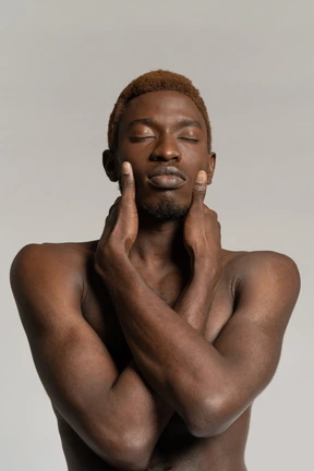 Portrait of man with closed eyes touching neck