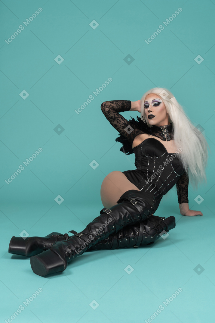 Drag queen laying on floor touching hair