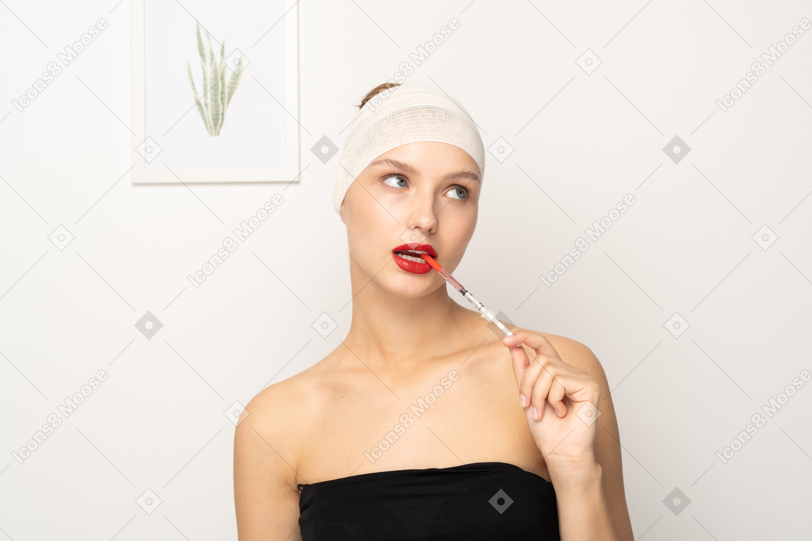 Portrait of a young woman sticking syringe into her mouth