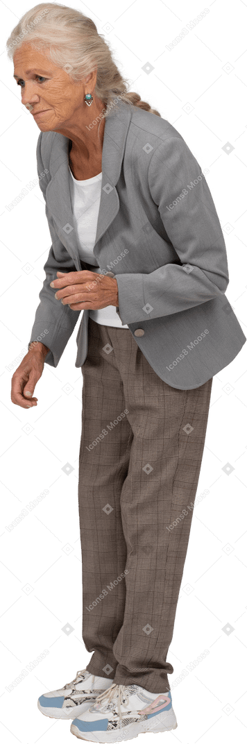 Side view of an upset old lady in suit bending down