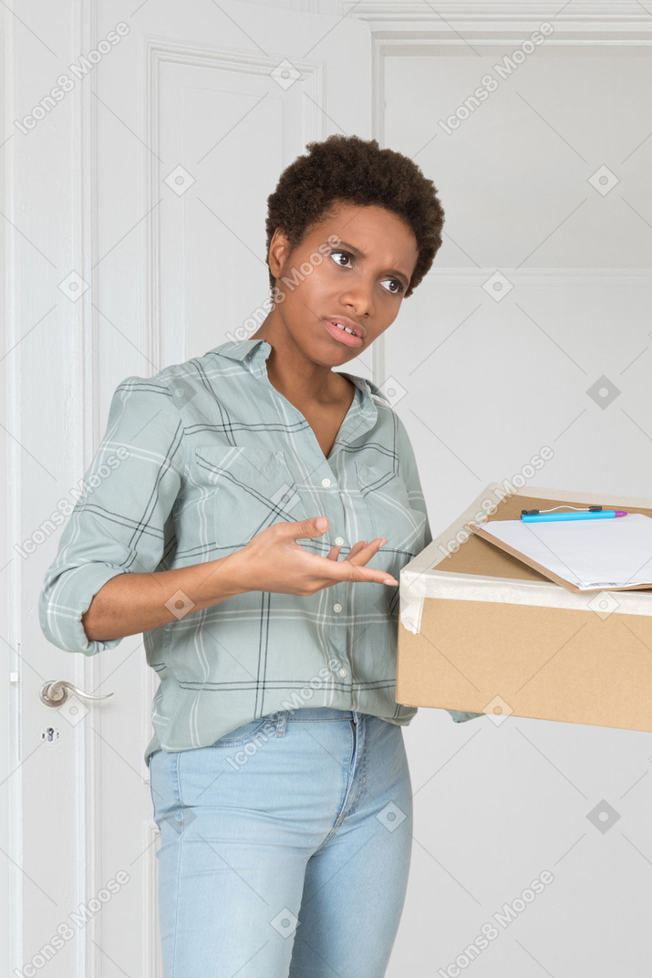 Confused courier delivering a package