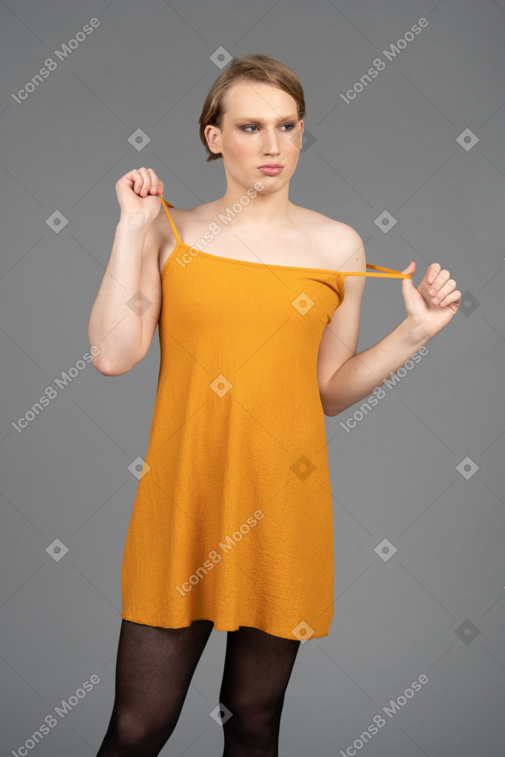 Portrait of a transgender person removing dress straps