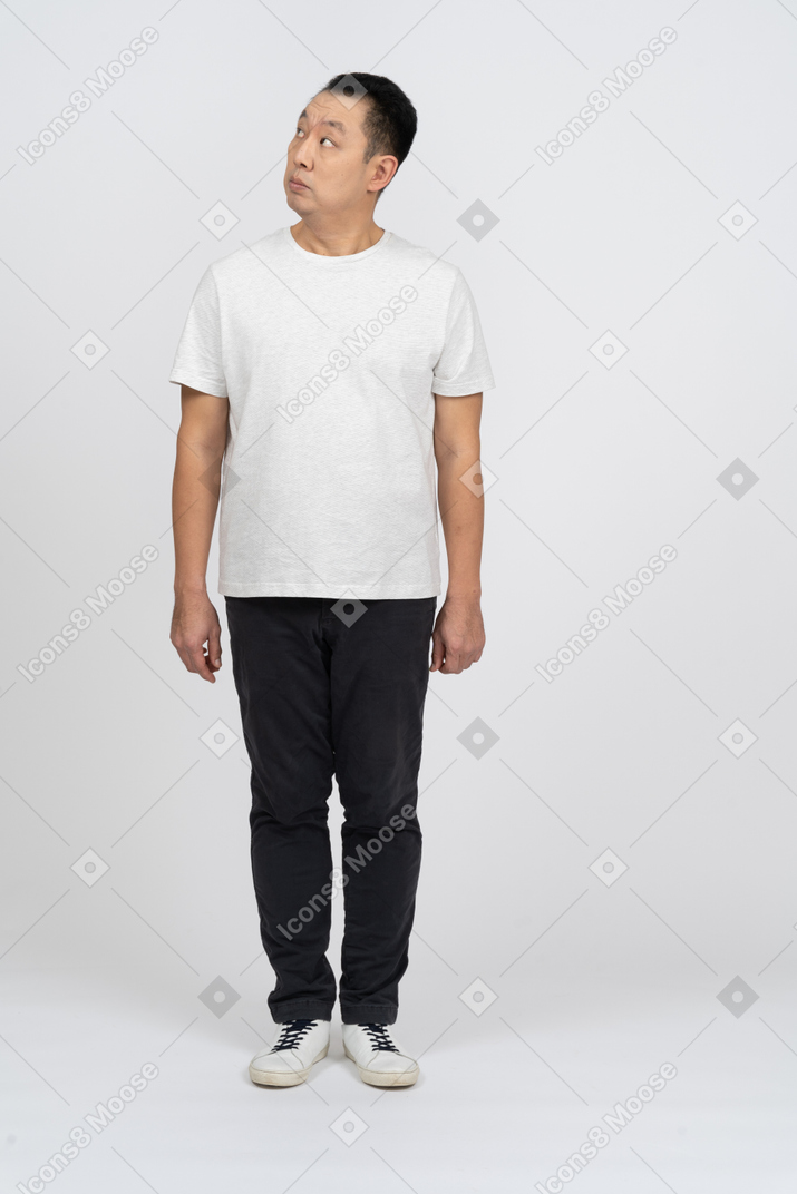 Front view of a man in casual clothes looking up