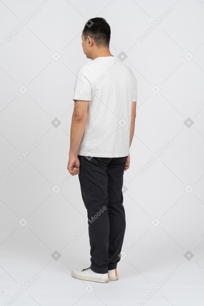 Man in casual clothes standing back to camera