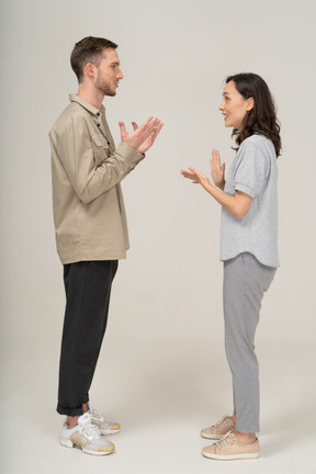 Side view of young couple speaking to each other