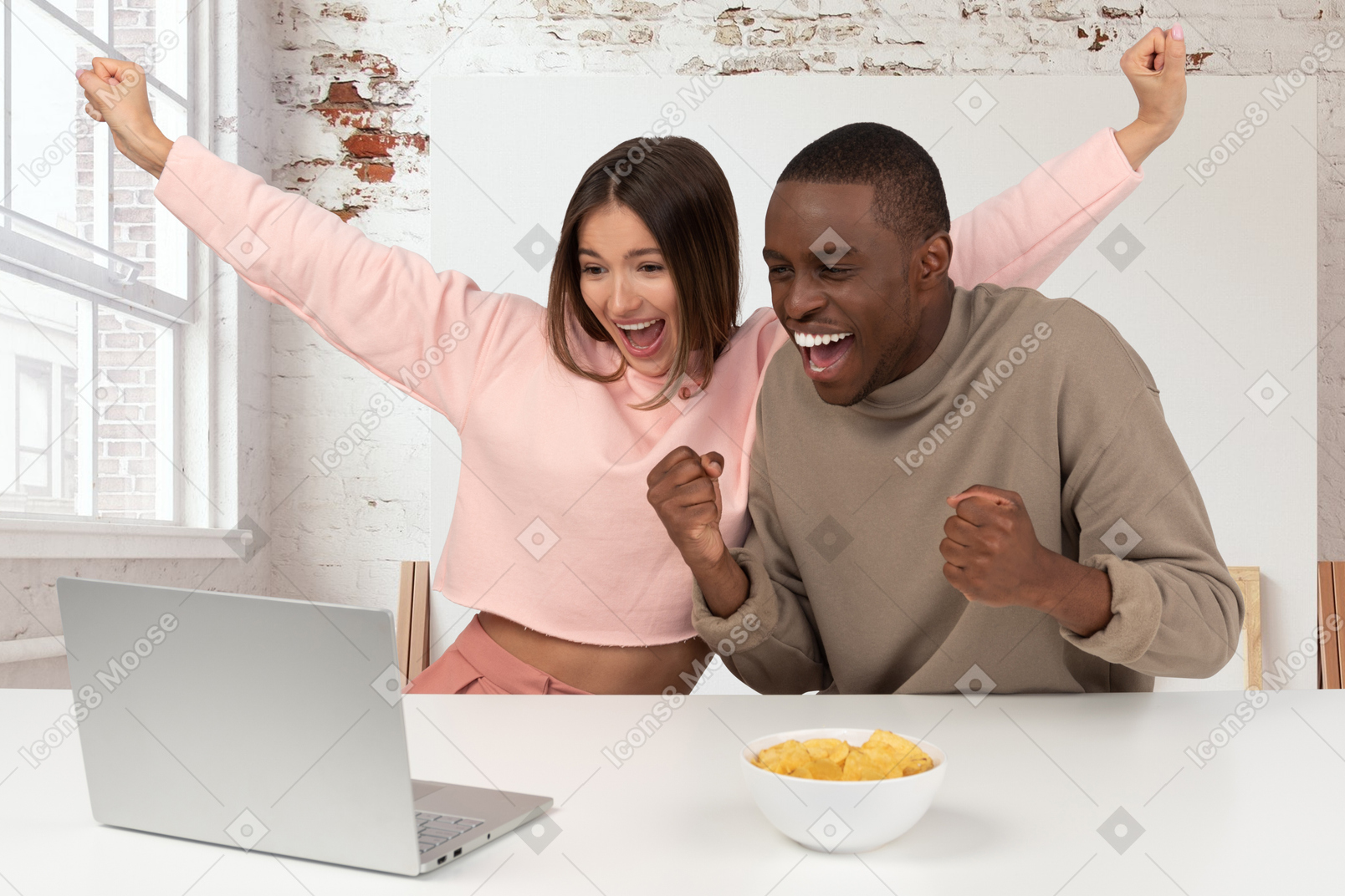 Joyful couple looking at laptop
