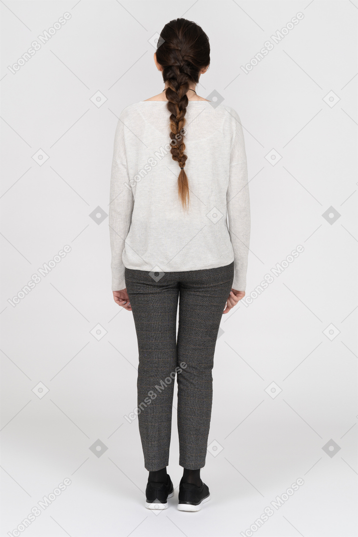 Slim caucasian female with long brown hair posing back to camera isolated over white background