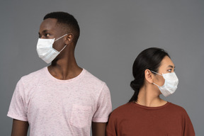 A young couple wearing face masks