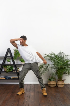 Handsome athletic man posing on the background of the apartment