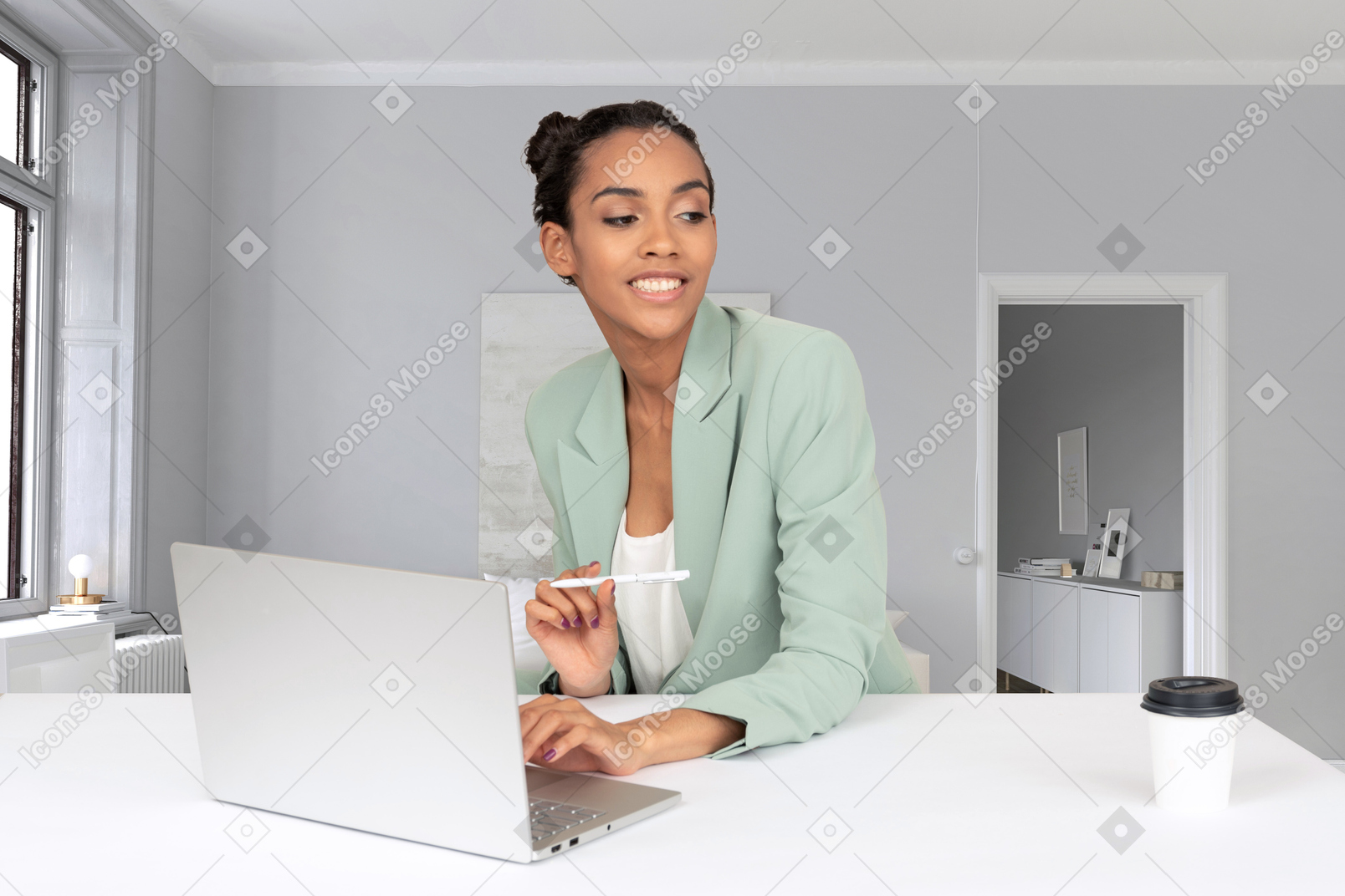 A woman sitting at a table with a laptop