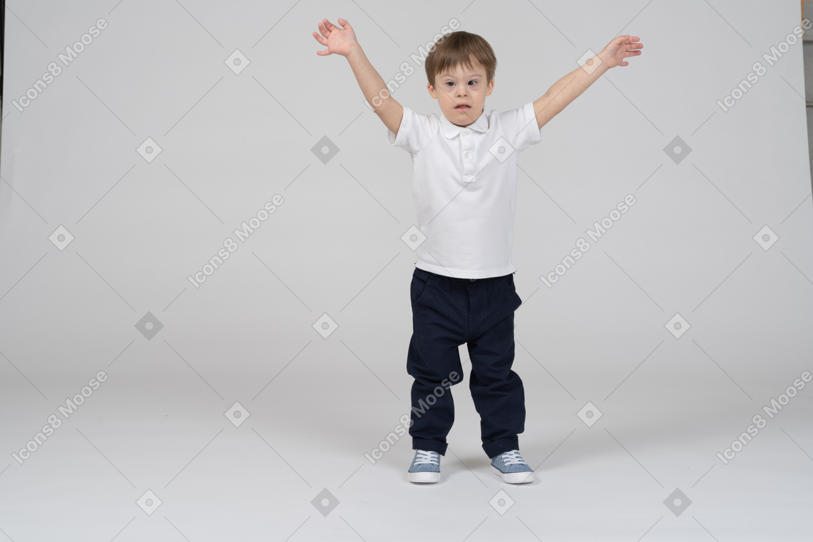 Vista frontal de un niño de pie con las manos en alto